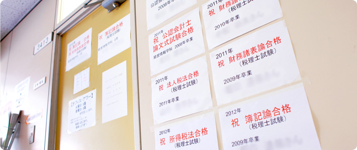 公認会計士試験、税理士試験に合格した在学生・卒業生の合格祝賀ポスターが貼ってある研究室ドア